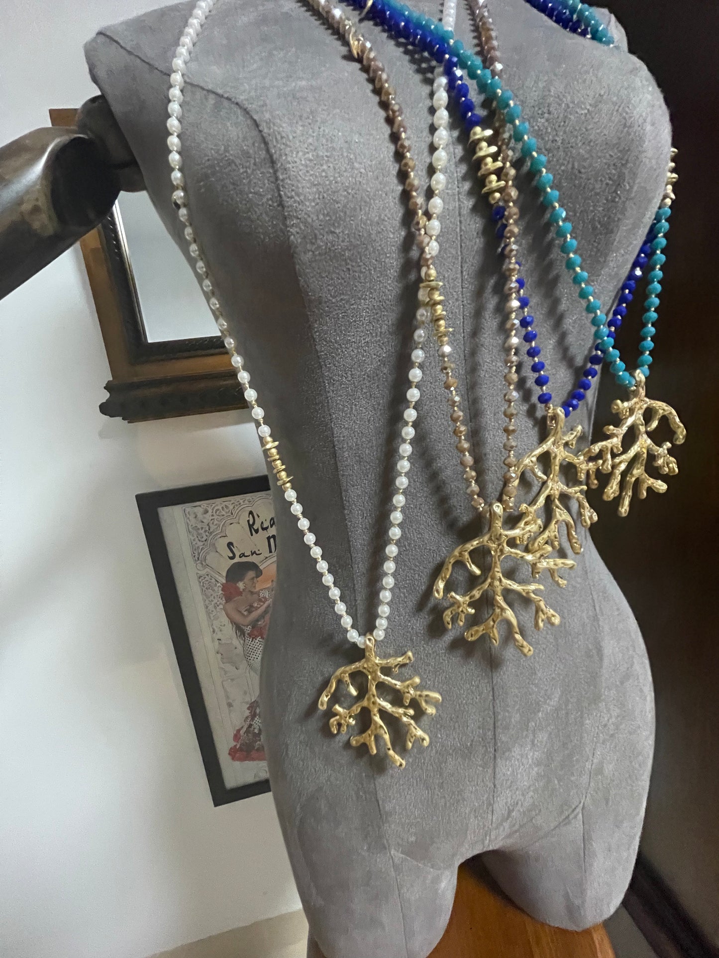 Long beaded and gold pendant with coral design piece