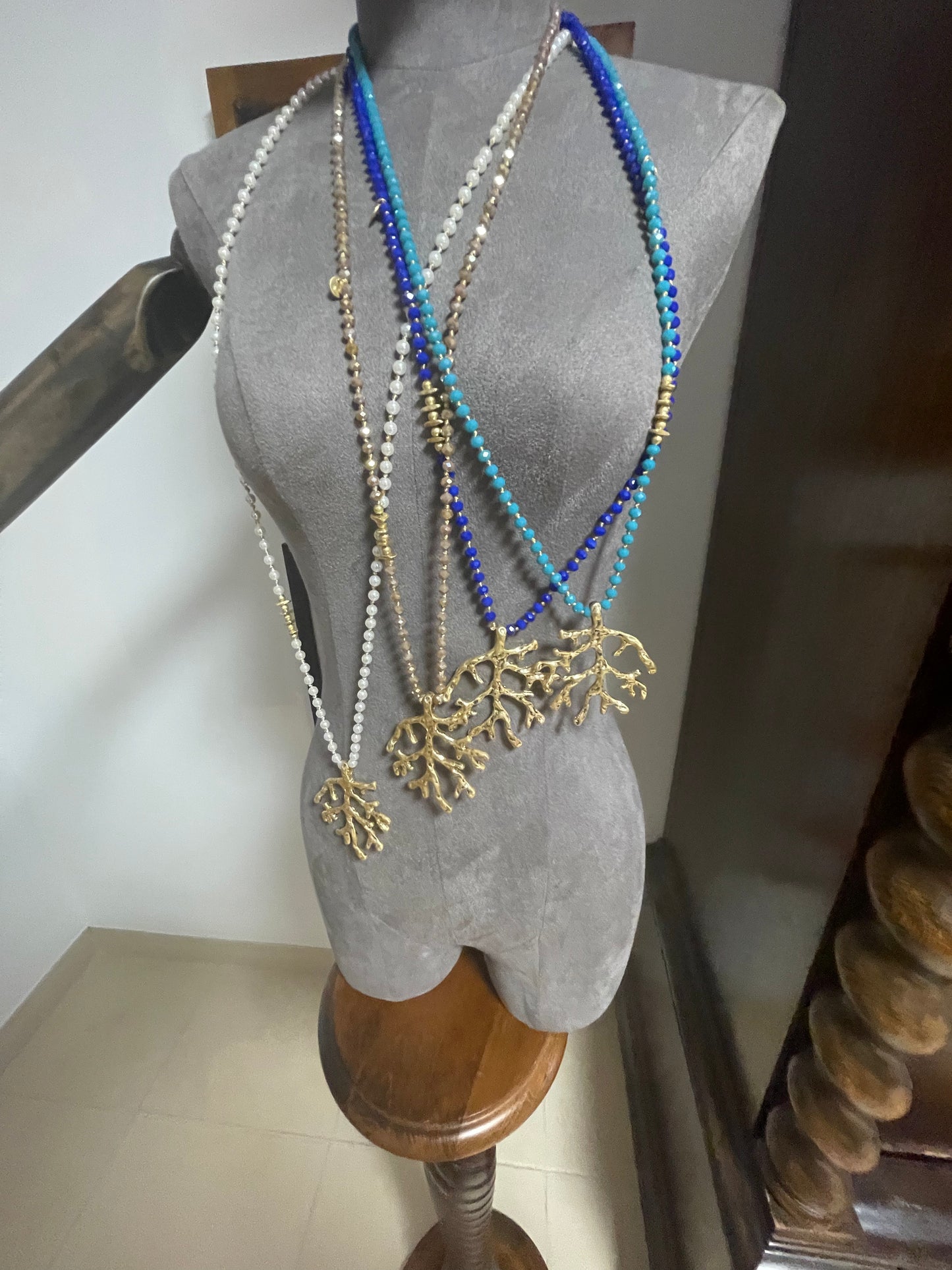 Long beaded and gold pendant with coral design piece