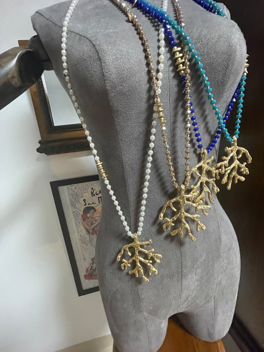 Long beaded and gold pendant with coral design piece